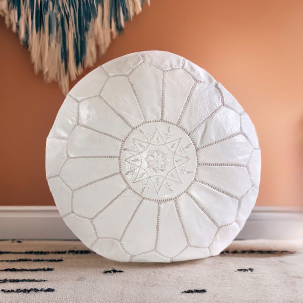 White Moroccan leather ottoman pouffe with intricate embroidery, handmade in Marrakech.