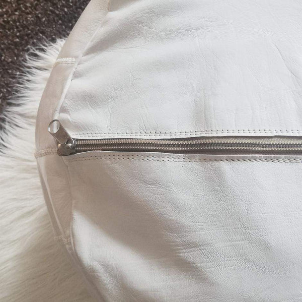 White Moroccan leather ottoman pouffe with zipper detail, handmade in Morocco.